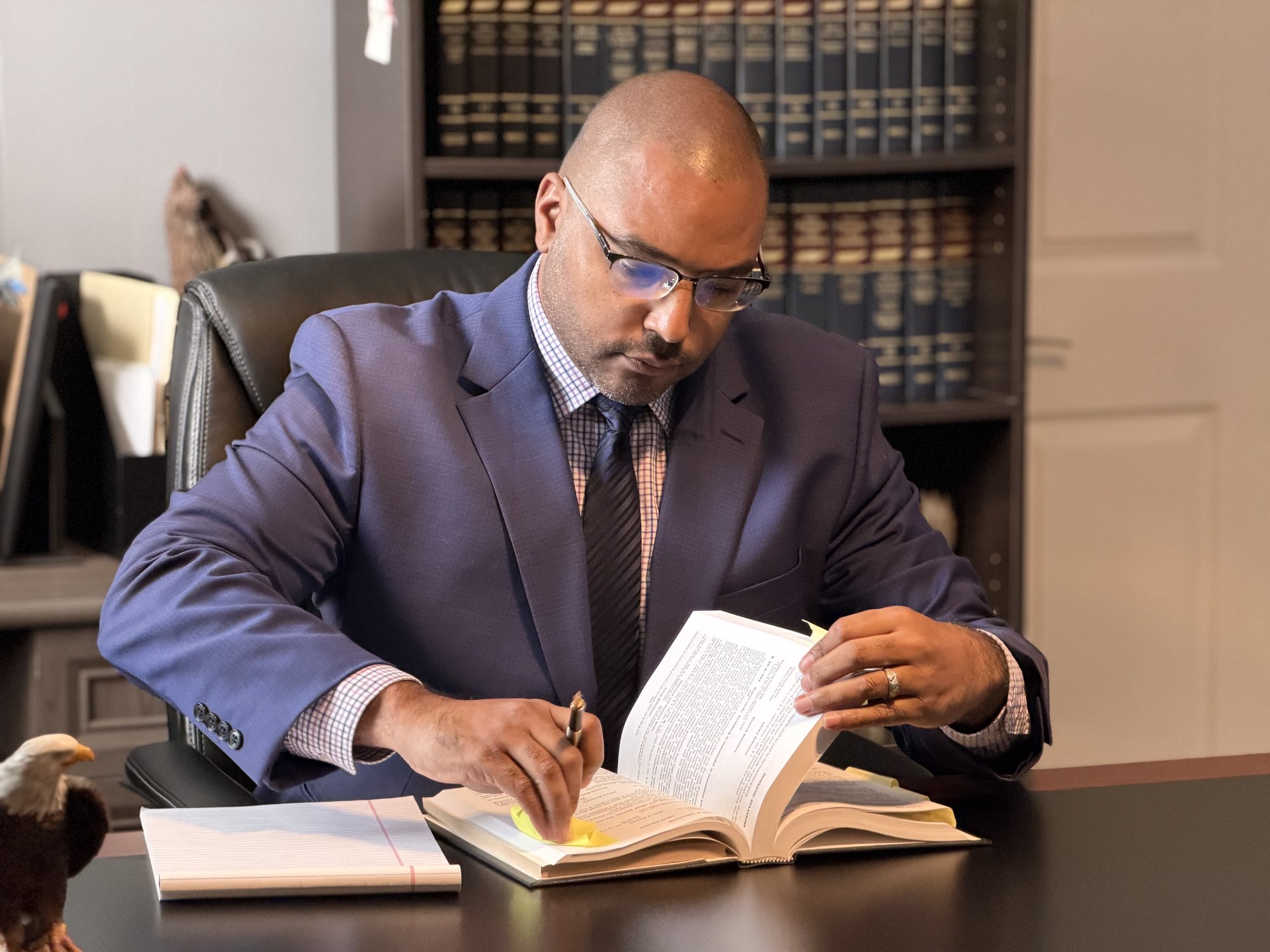 D. Colton Baker reading a law book at his desk